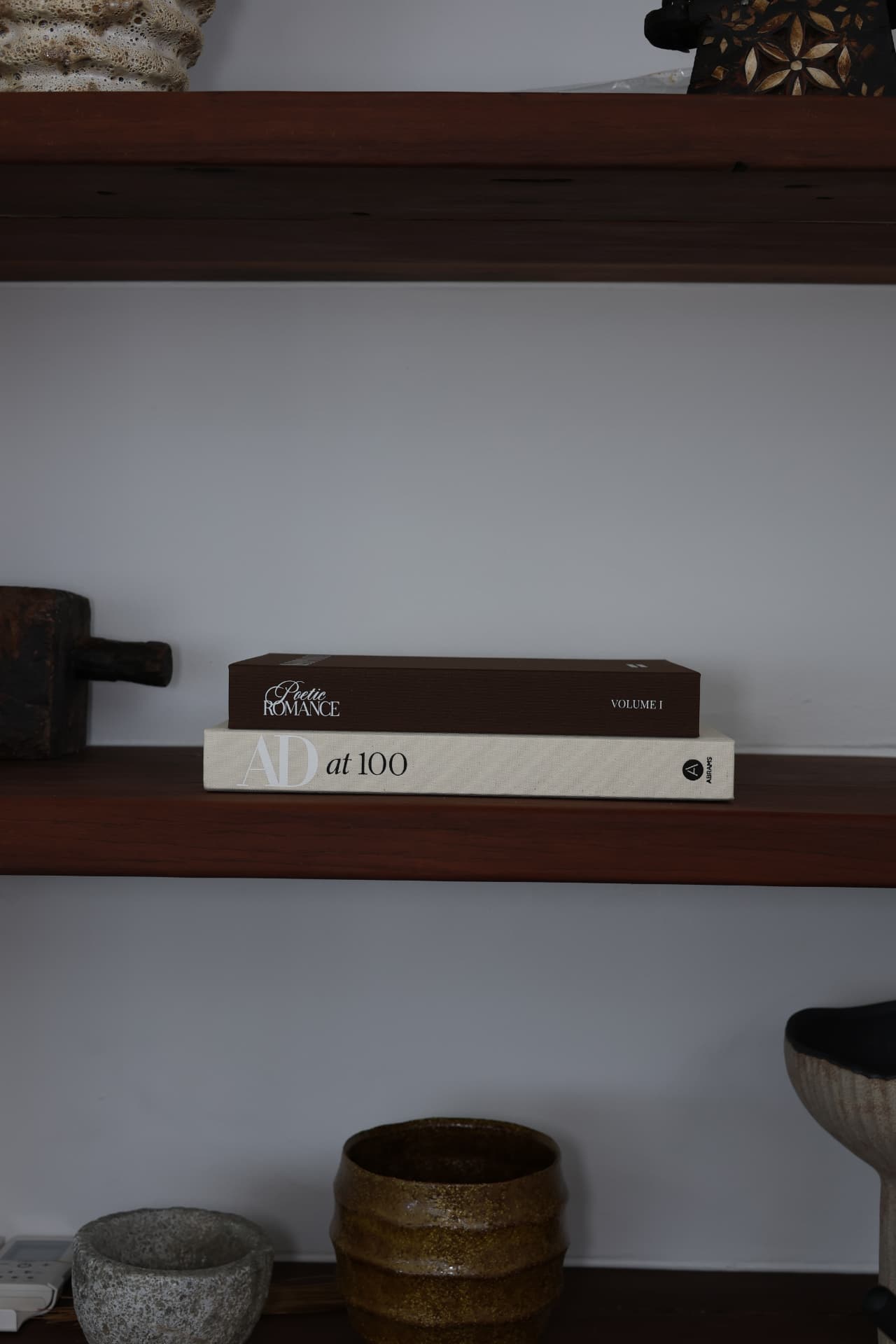 The Poetic Romance Keepsake Volume I on a shelf, resting on a large coffee-table book
