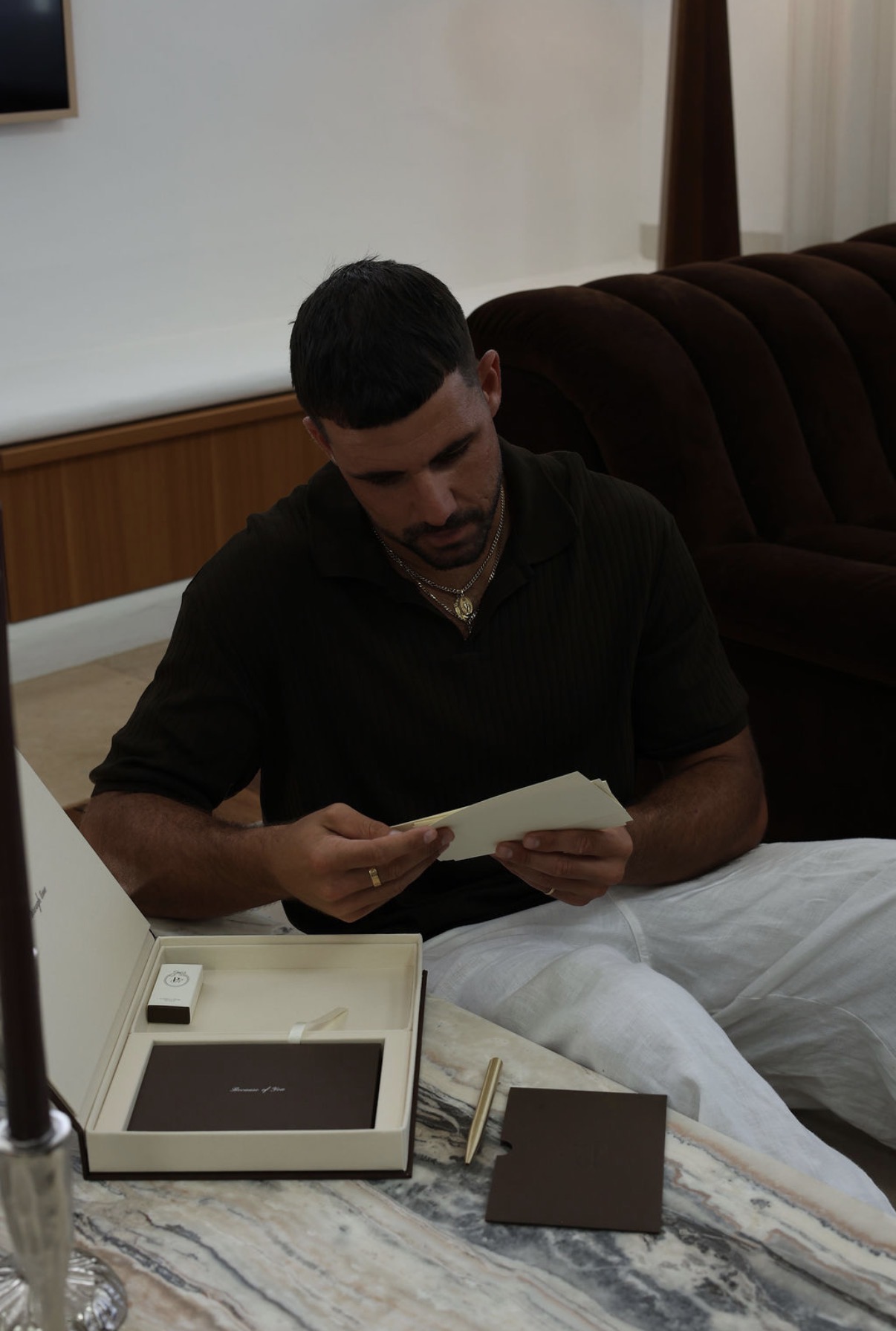 Man reading letters from the open Poetic Romance keepsake box