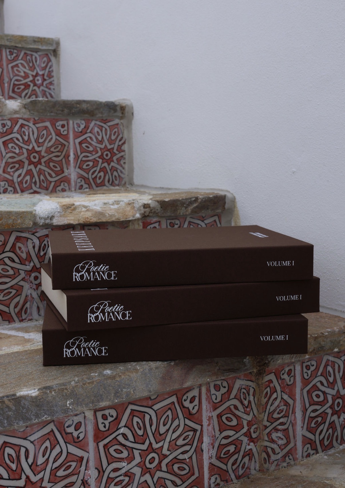 Three Poetic Romance Keepsake volumes stacked on tiled steps